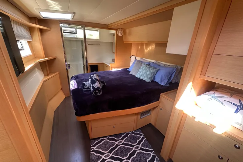 Sami Malu Yacht Photos Pics Luxurious cabin interior of 2017 Lagoon 52 F yacht with cozy bed and modern decor.