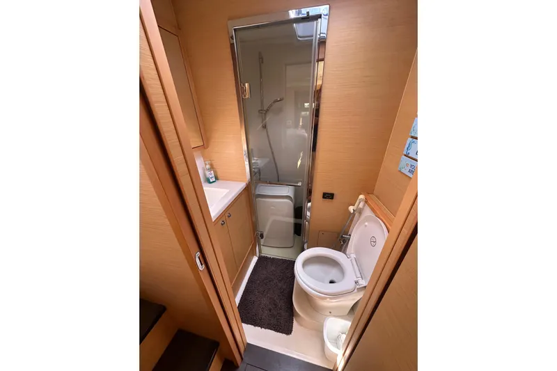 Sami Malu Yacht Photos Pics Bathroom interior of 2017 Lagoon 52 F yacht, featuring shower, sink, and toilet.