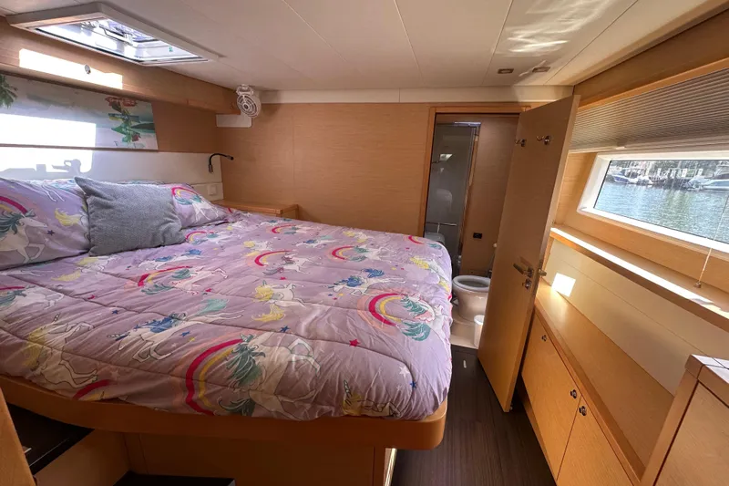 Sami Malu Yacht Photos Pics Luxurious cabin interior of 2017 Lagoon 52 F yacht with unicorn-themed bedding.