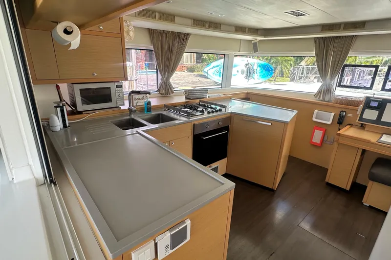 Sami Malu Yacht Photos Pics Modern kitchen interior of 2017 Lagoon 52 F yacht with appliances and large windows.