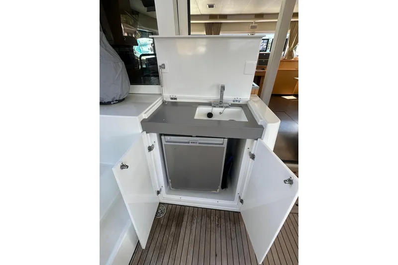 Sami Malu Yacht Photos Pics Outdoor kitchenette on 2017 Lagoon 52 F yacht with sink and mini fridge.