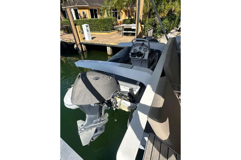 Sami Malu Yacht Photos Pics 2017 Lagoon 52 F boat docked, featuring an outboard motor and steering console.