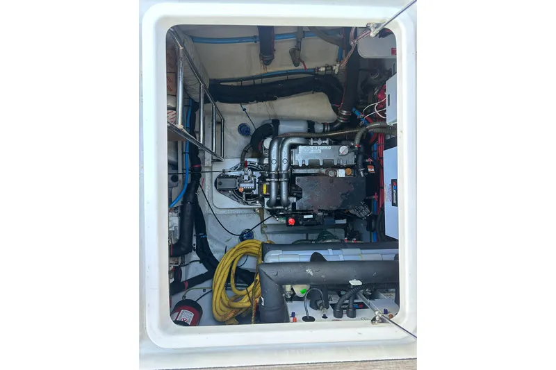 Sami Malu Yacht Photos Pics Engine compartment of 2017 Lagoon 52 F catamaran, showcasing mechanical components and wiring.