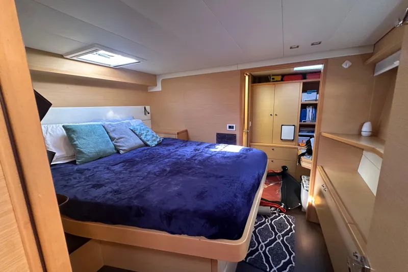 Sami Malu Yacht Photos Pics Luxurious cabin interior of 2017 Lagoon 52 F yacht with cozy bedding and ample storage.