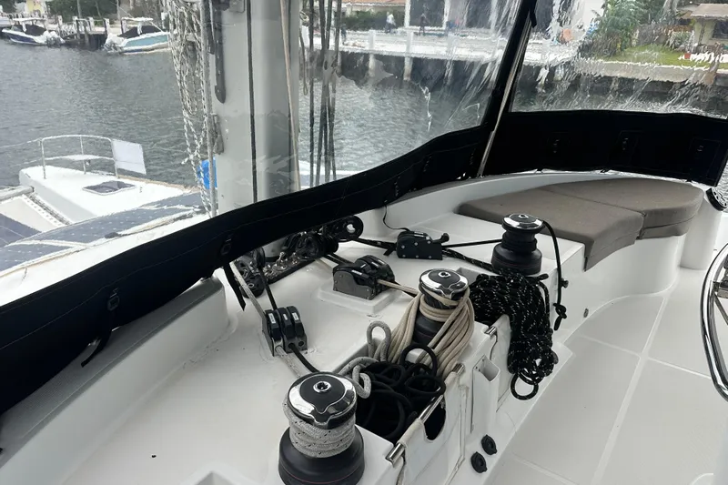 Sami Malu Yacht Photos Pics Cockpit of 2017 Lagoon 52 F yacht with winches and ropes, docked by the water.