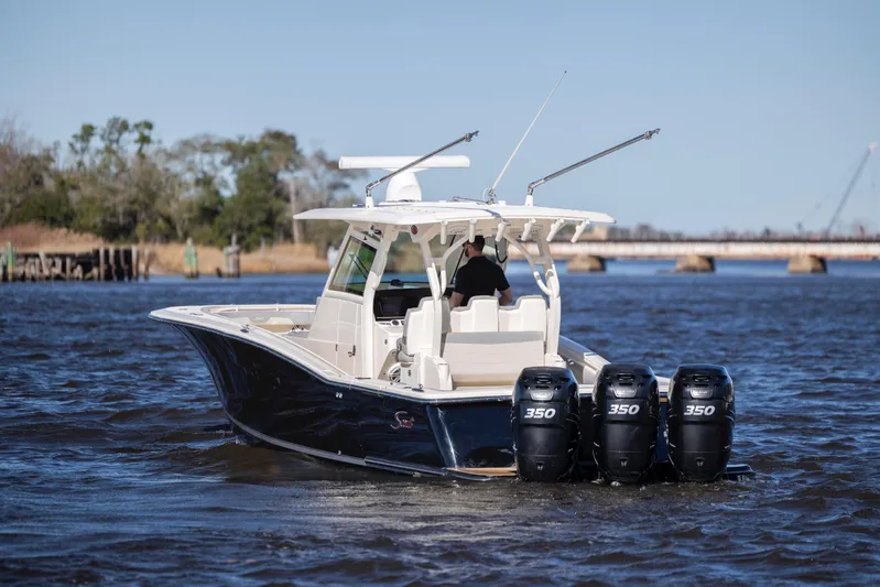  Yacht Photos Pics 2019 Scout 355 LXF boat with triple 350 engines on a river.