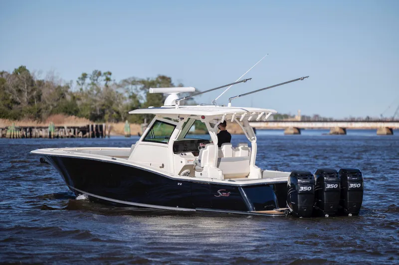 Yacht Photos Pics 2019 Scout 355 LXF boat with triple engines cruising on a river.