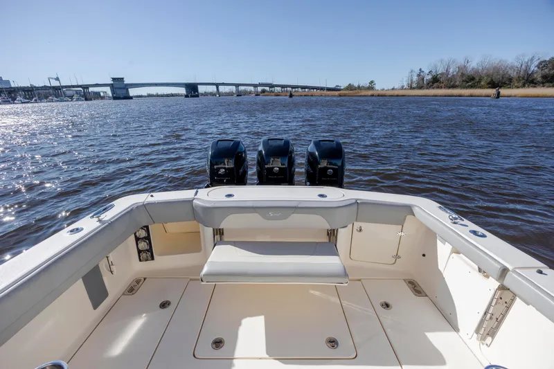  Yacht Photos Pics 2019 Scout 355 LXF boat with triple engines on a sunny river.