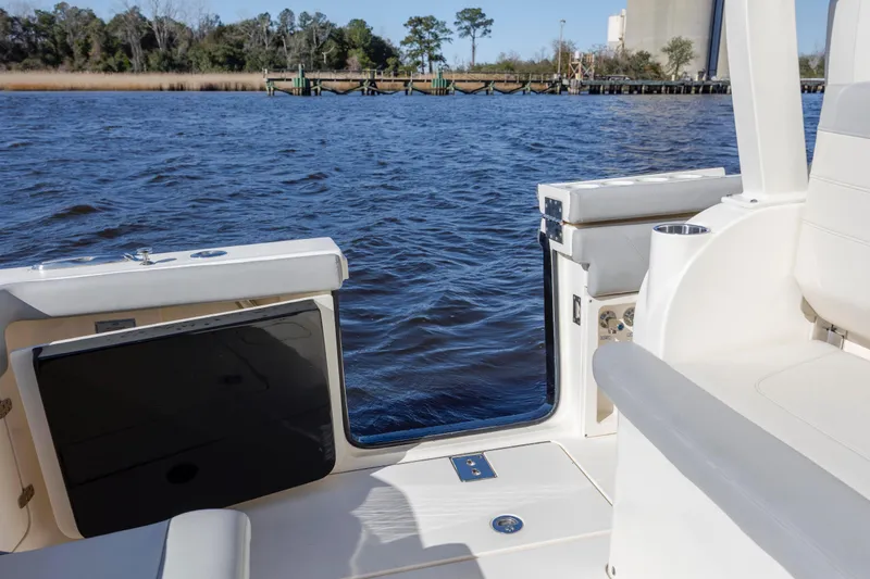  Yacht Photos Pics 2019 Scout 355 LXF boat interior with open side door, overlooking water and shoreline.