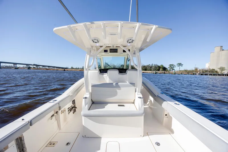  Yacht Photos Pics 2019 Scout 355 LXF boat interior on a sunny day, with water and bridge in background.