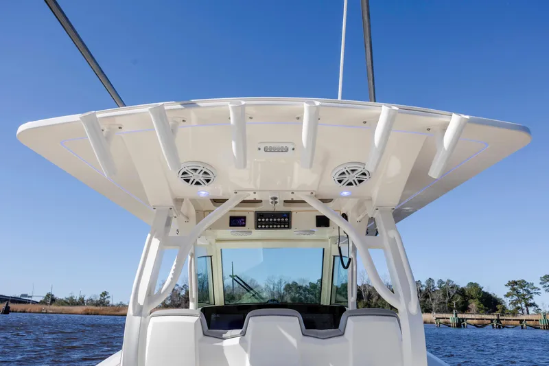  Yacht Photos Pics 2019 Scout 355 LXF boat helm with speakers and electronics under a clear blue sky.