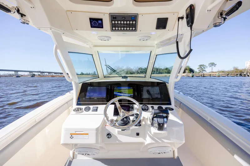  Yacht Photos Pics 2019 Scout 355 LXF boat cockpit with advanced navigation system on open water.