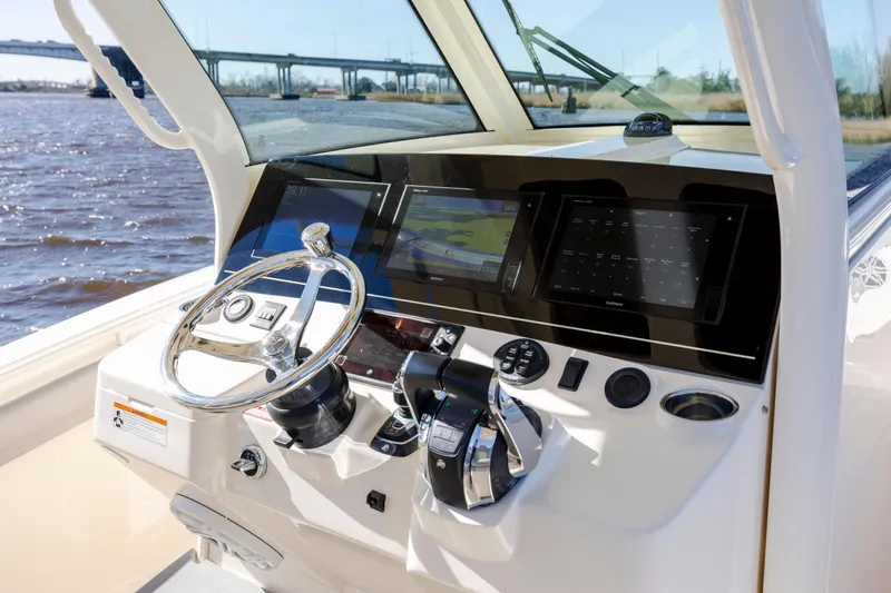  Yacht Photos Pics 2019 Scout 355 LXF boat helm with modern navigation displays and controls.
