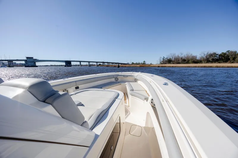  Yacht Photos Pics 2019 Scout 355 LXF boat cruising on a sunny day near a bridge.