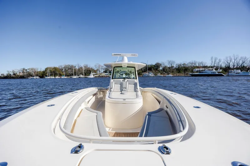  Yacht Photos Pics 2019 Scout 355 LXF boat on water, clear sky, luxurious seating.