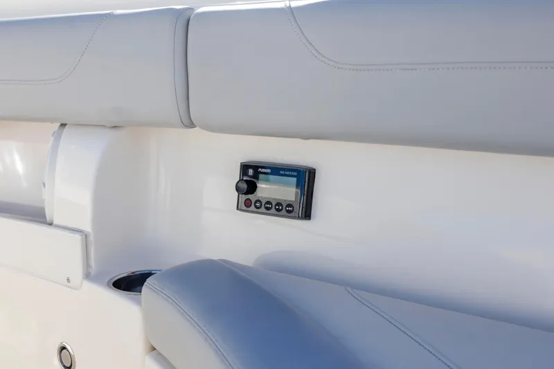  Yacht Photos Pics 2019 Scout 355 LXF boat interior with Fusion stereo system and cushioned seating.