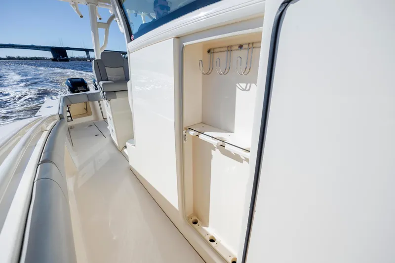  Yacht Photos Pics 2019 Scout 355 LXF boat interior with rod holders, cruising on water.