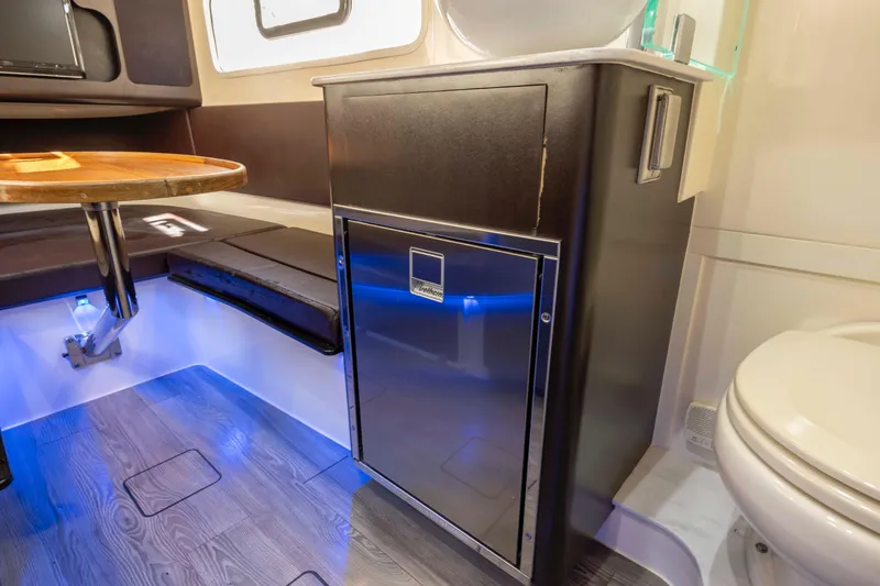  Yacht Photos Pics 2019 Scout 355 LXF cabin interior with seating, table, and compact fridge.