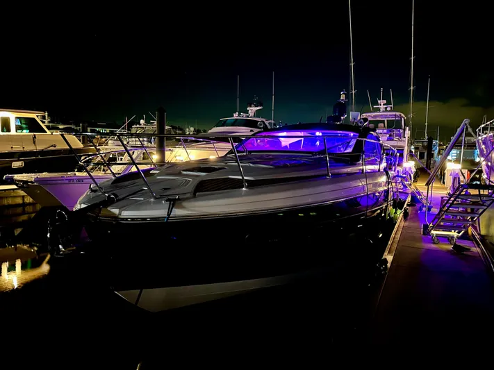  Yacht Photos Pics 2021 Azimut Atlantis 45 yacht docked at night with vibrant blue lighting.