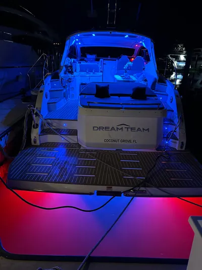  Yacht Photos Pics Azimut Atlantis 45 yacht, 2021 model, illuminated with blue and red lights at night.