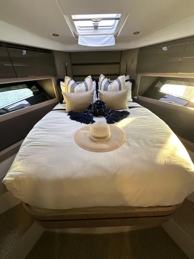  Yacht Photos Pics Luxurious bedroom interior of 2021 Azimut Atlantis 45 yacht with elegant bedding and natural light.