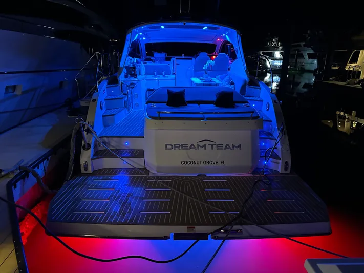  Yacht Photos Pics Azimut Atlantis 45 yacht, 2021 model, illuminated with blue and red lights at night.