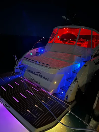  Yacht Photos Pics Azimut Atlantis 45 yacht, 2021 model, illuminated with vibrant red and blue lights at night.