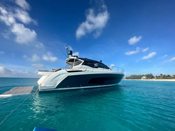  Yacht Photos Pics Azimut Atlantis 45 yacht, 2021 model, anchored in clear blue waters under a sunny sky.
