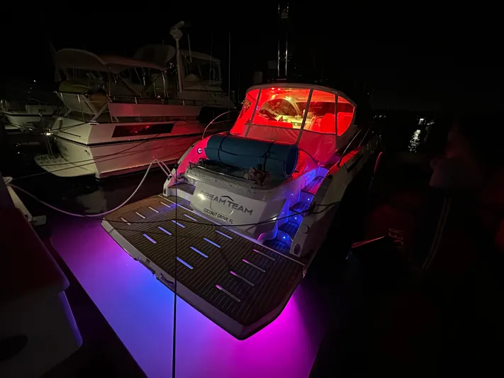  Yacht Photos Pics 2021 Azimut Atlantis 45 yacht with vibrant red and blue lights at night.