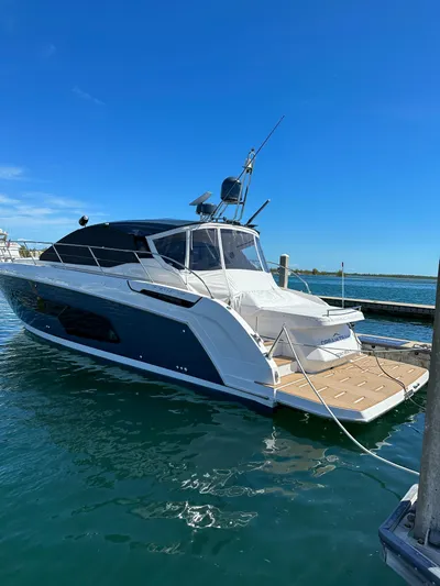  Yacht Photos Pics 2021 Azimut Atlantis 45 yacht docked in a marina under clear blue skies.