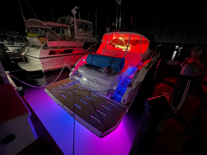  Yacht Photos Pics Azimut Atlantis 45 yacht, 2021 model, illuminated with vibrant red and blue lights at night.