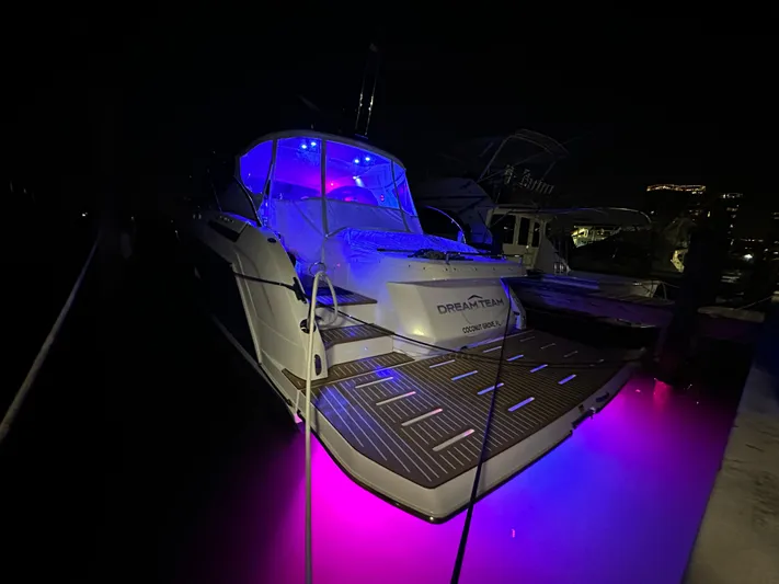  Yacht Photos Pics Azimut Atlantis 45 yacht, 2021 model, illuminated with vibrant blue and pink lights at night.