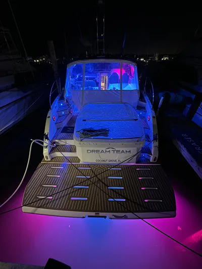  Yacht Photos Pics Azimut Atlantis 45 yacht, 2021 model, illuminated with vibrant blue and pink lights at night.