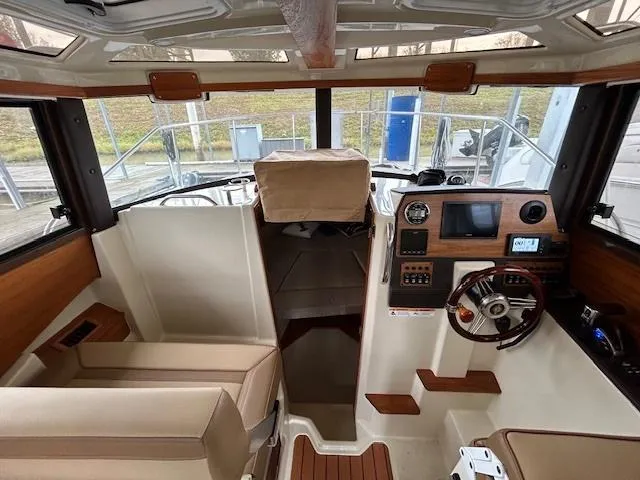  Yacht Photos Pics Interior of 2023 Ranger Tugs R23 boat, featuring helm, seating, and navigation equipment.