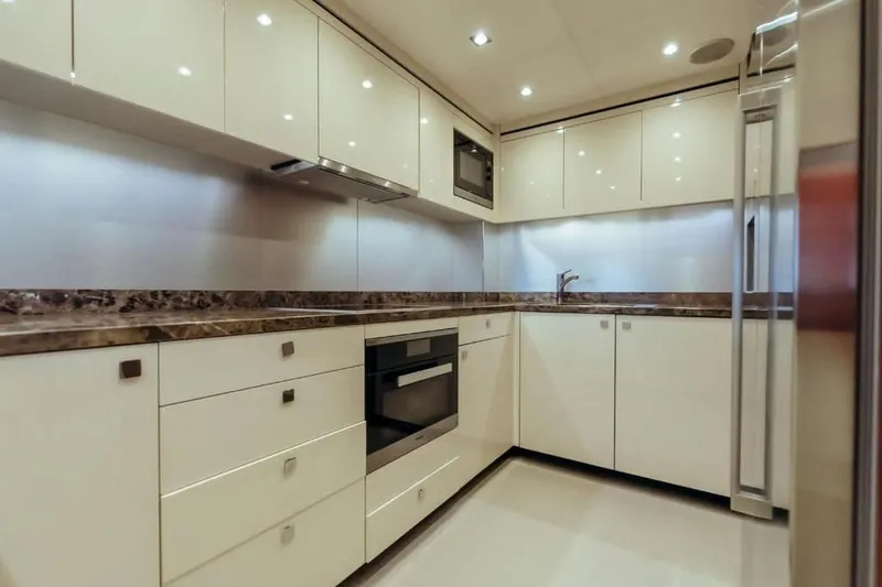  Yacht Photos Pics Luxurious kitchen interior on 2018 Sunseeker 95 Yacht with modern appliances and sleek design.