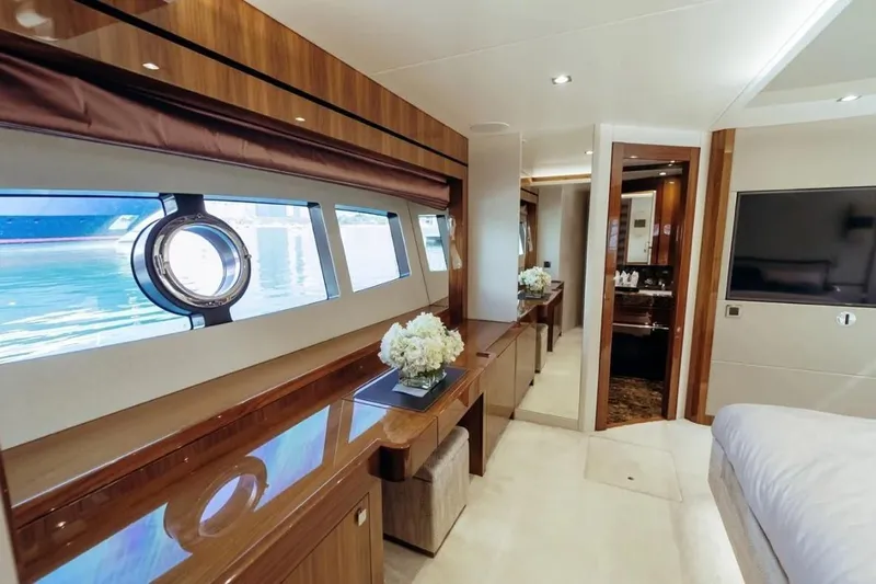  Yacht Photos Pics Luxurious interior of 2018 Sunseeker 95 Yacht with elegant wood finishes and large windows.