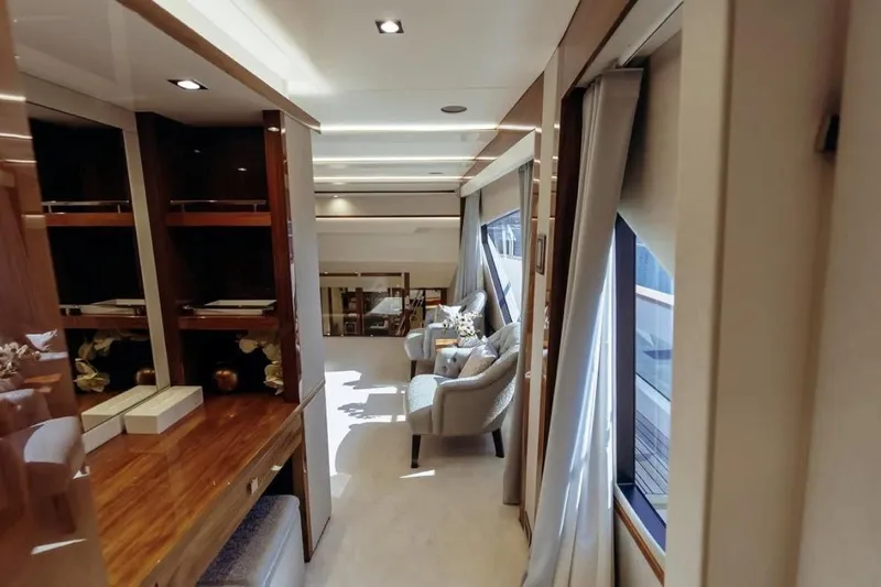  Yacht Photos Pics Luxurious interior of 2018 Sunseeker 95 Yacht with elegant seating and wooden accents.