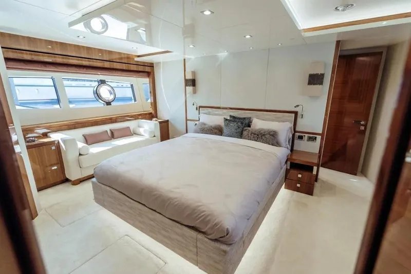  Yacht Photos Pics Luxurious bedroom interior of 2018 Sunseeker 95 Yacht with elegant furnishings and natural light.