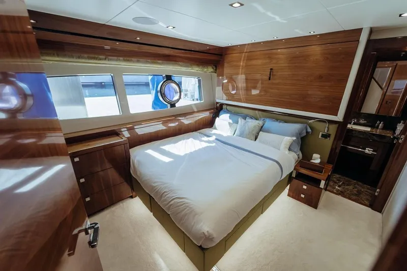  Yacht Photos Pics Luxurious 2018 Sunseeker 95 Yacht bedroom with elegant wood finishes and large windows.