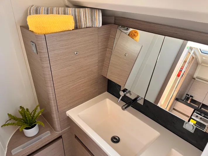 Hanse 418 #303 San Yacht Photos Pics Modern bathroom in 2023 Hanse 418 yacht with sink, mirror, and storage.