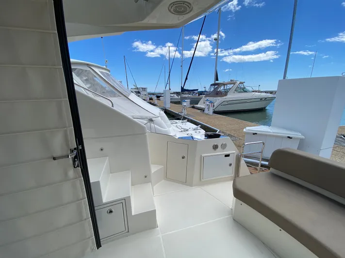 Inconseavable Yacht Photos Pics Marquis 500 Sport Bridge 2014 at dock, sunny day.