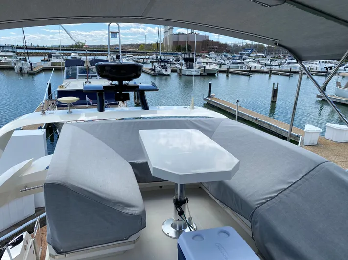 Inconseavable Yacht Photos Pics 2014 Marquis 500 Sport Bridge in a sunny marina.