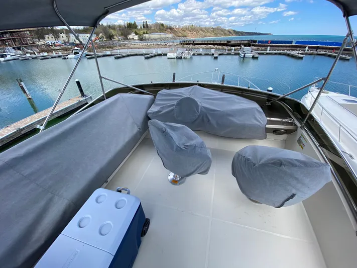 Inconseavable Yacht Photos Pics 2014 Marquis 500 Sport Bridge in a serene harbor.