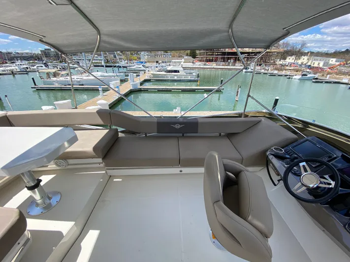 Inconseavable Yacht Photos Pics 2014 Marquis 500 Sport Bridge interior with marina view.