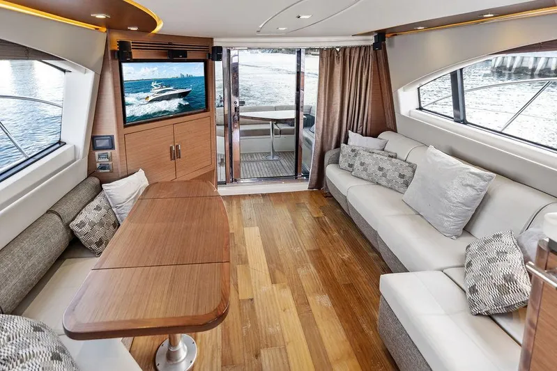  Yacht Photos Pics Luxurious interior of 2015 Sea Ray 510 Fly yacht with elegant seating and wooden flooring.