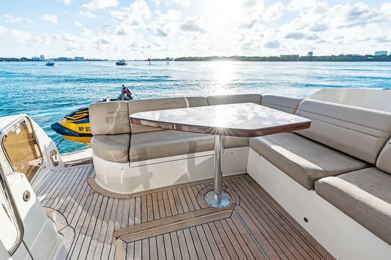  Yacht Photos Pics 2015 Sea Ray 510 Fly yacht deck with seating and table, overlooking serene water.