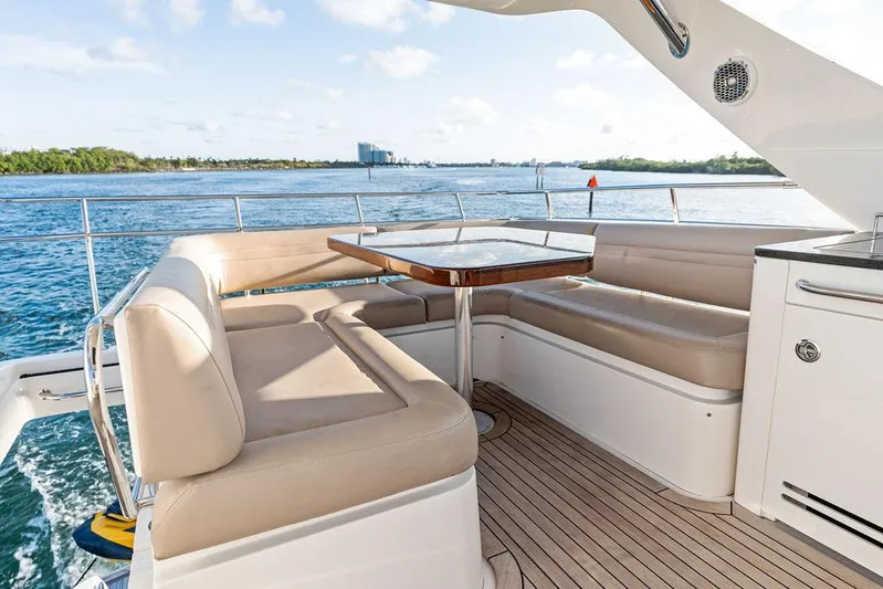  Yacht Photos Pics 2015 Sea Ray 510 Fly yacht deck with seating and table, overlooking serene water.