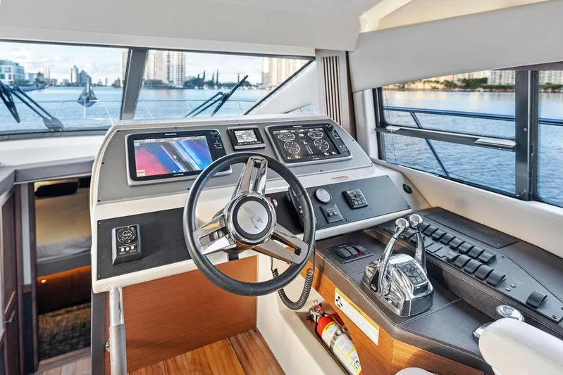  Yacht Photos Pics 2015 Sea Ray 510 Flybridge helm with modern controls and waterfront view.