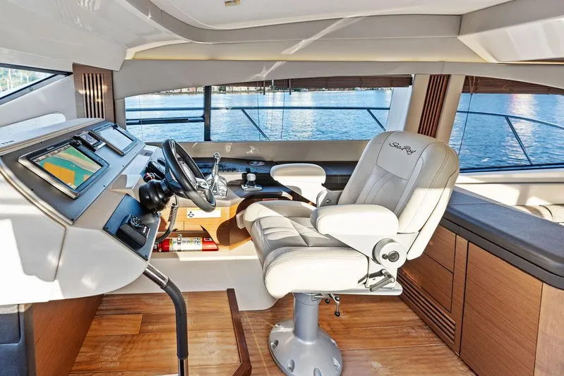  Yacht Photos Pics 2015 Sea Ray 510 Flybridge helm with luxurious captain's chair and modern navigation equipment.