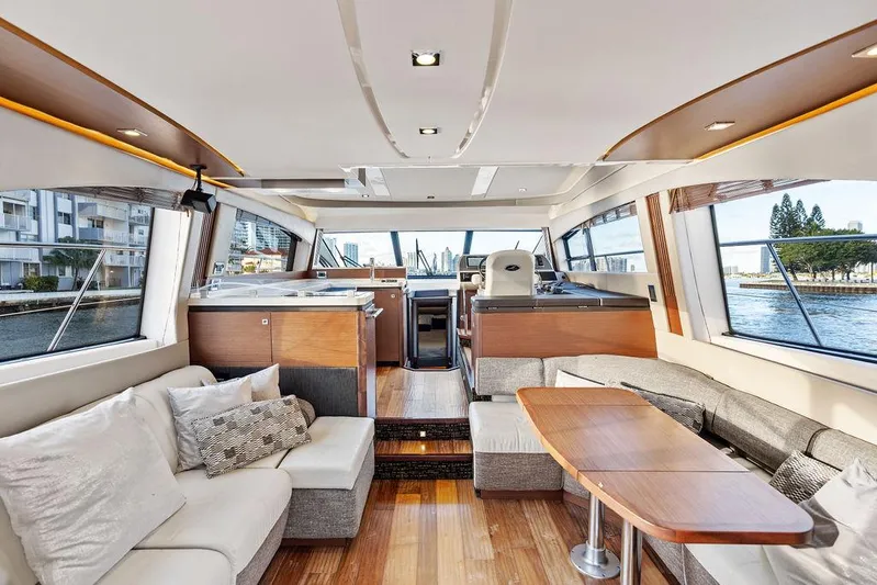  Yacht Photos Pics Luxurious interior of 2015 Sea Ray 510 Fly yacht with modern furnishings and panoramic windows.